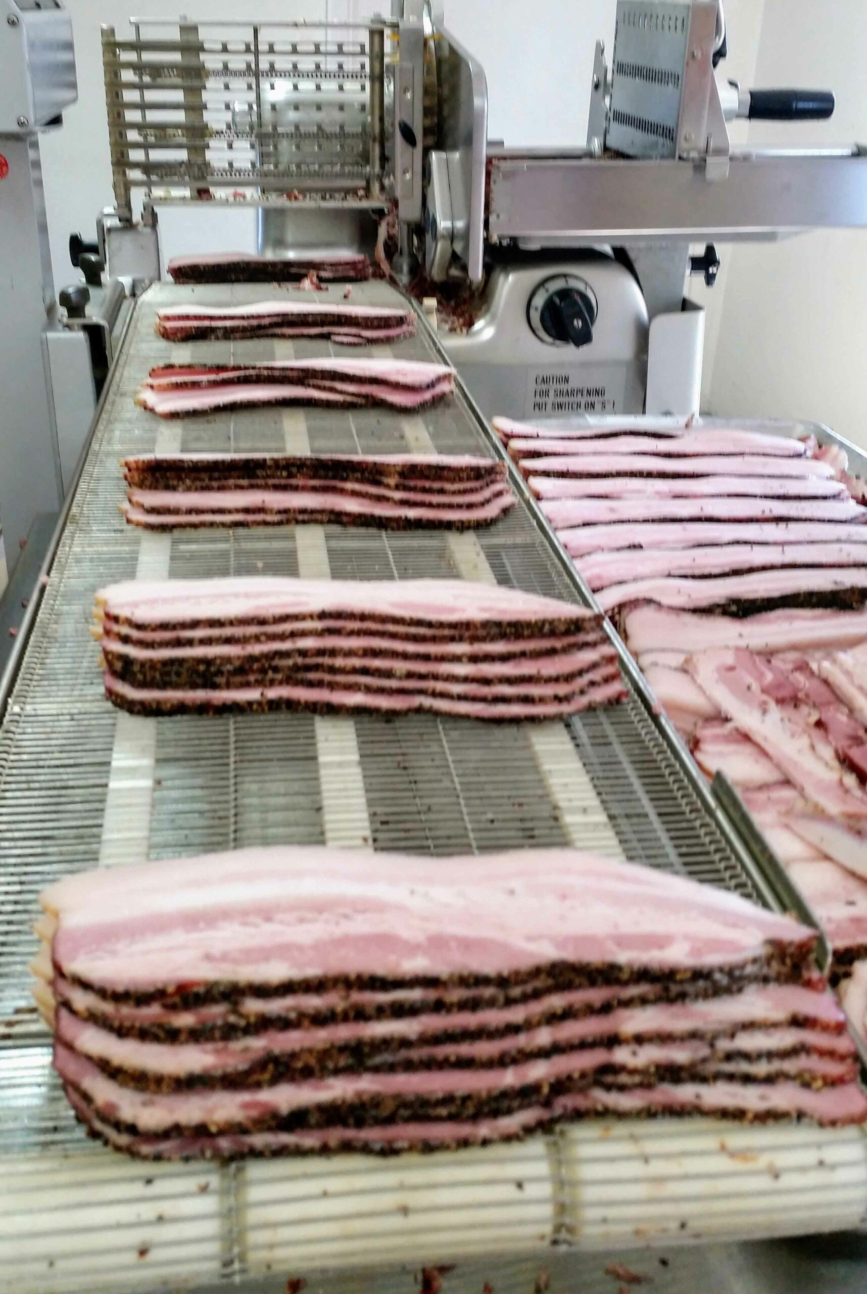Processing bacon at Century Oak Packing Co