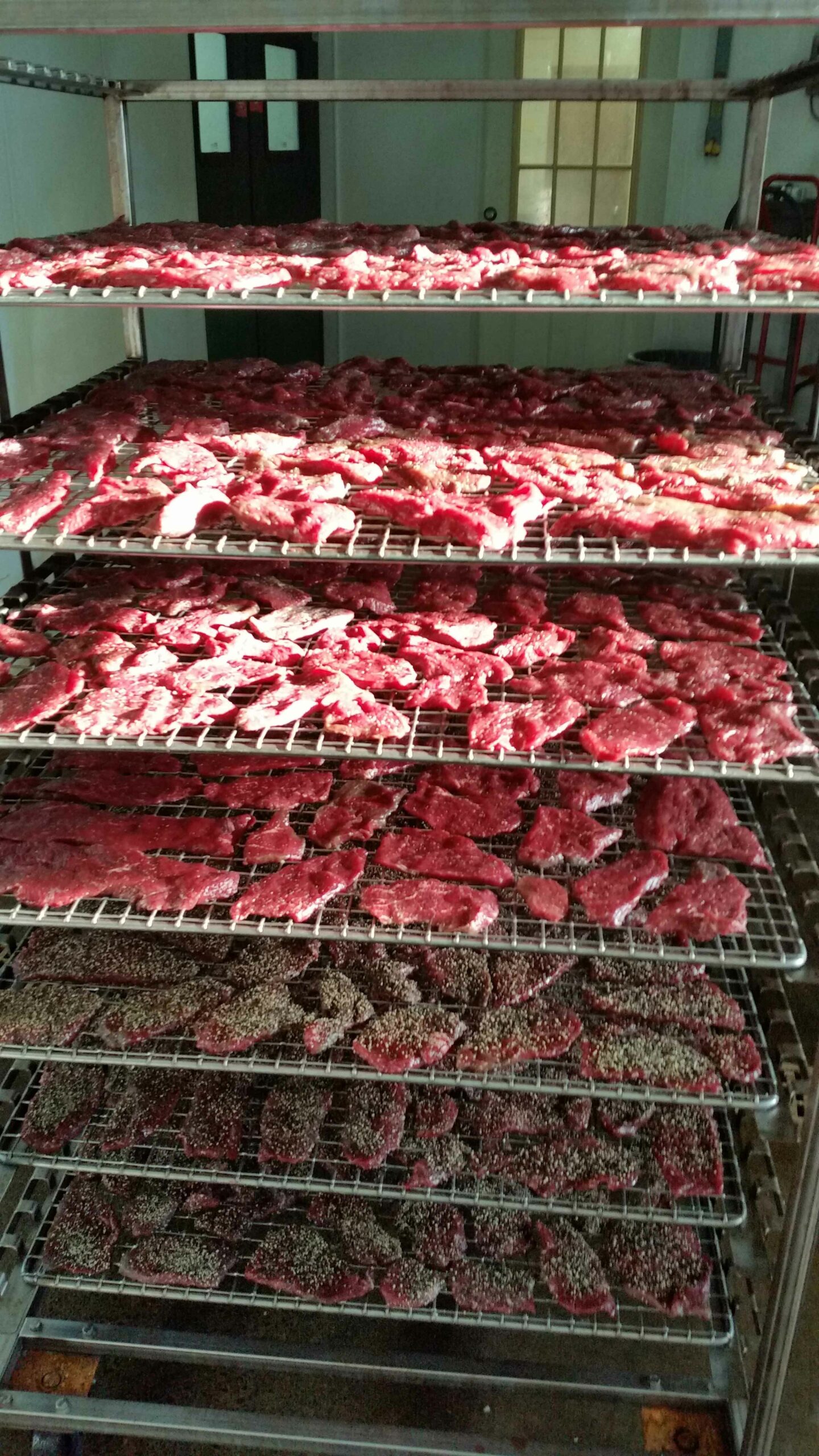 Drying meat on racks at Century Oak Packing Co