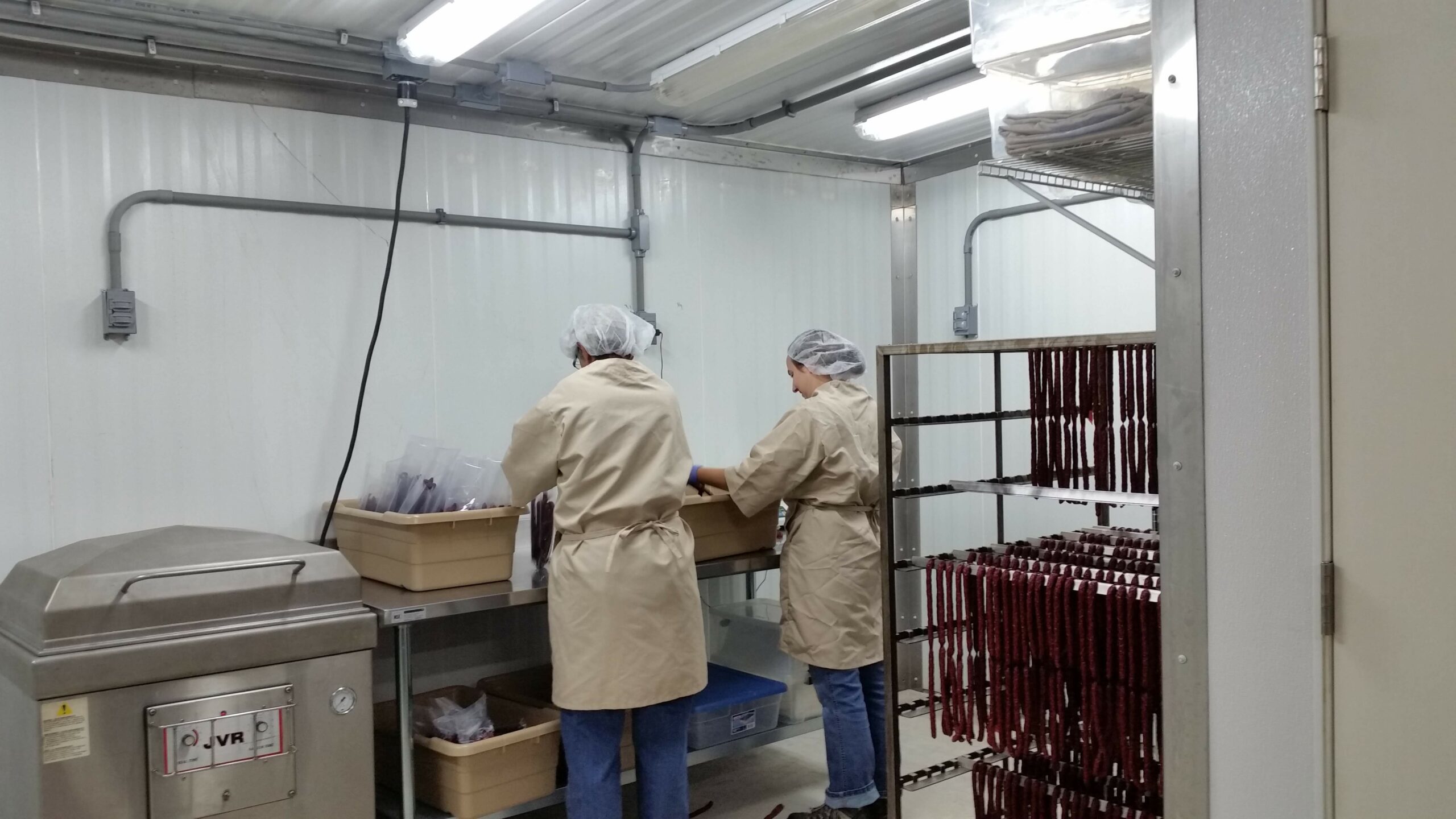 Processing meat at Century Oak Packing Co