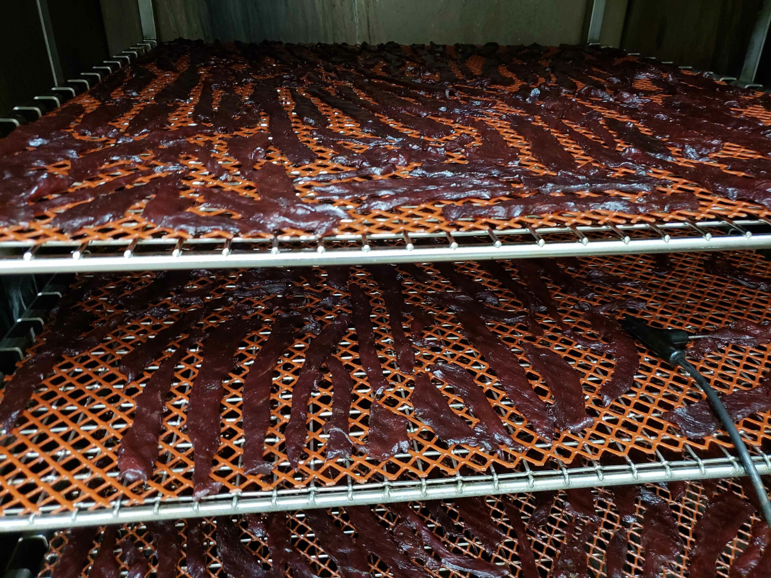 Racks of jerky at Century Oak Packing Co